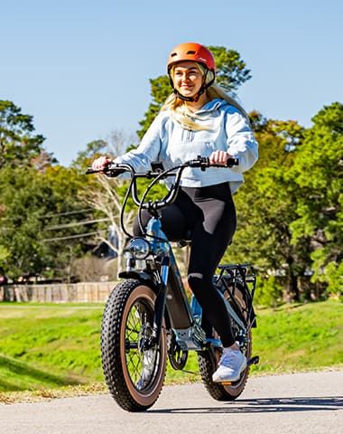 Rider enjoying a sunny e-bike ride on a paved North Texas trail